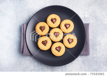 Homemade cookies in the shape of hearts on the plate, gray background. Concept Valentine's Day. copy space. Homemade cookies in the shape of hearts on the plate, gray background. Concept Valentine's Day. copy space. 73583981