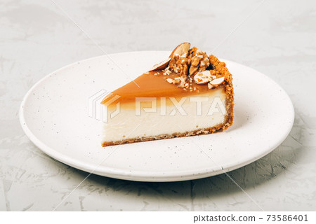 Cheesecake with salted caramel and nuts. Cheesecake with salted caramel and nuts. 73586401