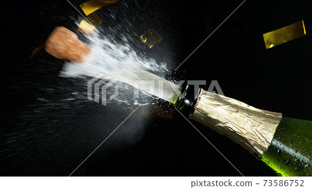 Close-up of explosion of champagne bottle 73586752