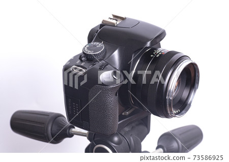Digital photo camera on black tripod isolated on white background Digital photo camera on black tripod isolated on white background 73586925
