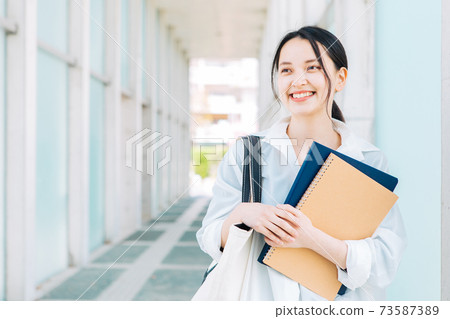 Smiling female college student 73587389