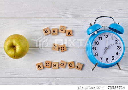 Alarm clock and green apple. Alarm clock and green apple. 73588714