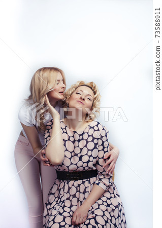 mother with teen daughter together posing happy smiling isolated on white background with copyspace, lifestyle people concept mother with teen daughter together posing happy smiling isolated on white background with copyspace, lifestyle people concept 73588911