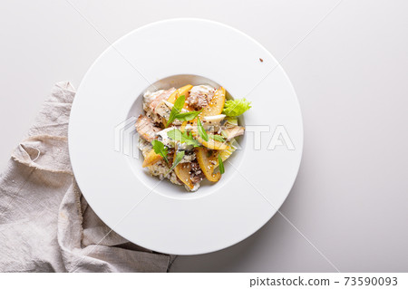 Quick and healthy food recipes. Salad with vegetables, herbs, turkey sous vide meat, caramelized pear, blue cheese with sesame dressing on white plate. Mediterranean dish recipes. Top view. Copy space Quick and healthy food recipes. Salad with vegetables, herbs, turkey sous vide meat, caramelized pear, blue cheese with sesame dressing on white plate. Mediterranean dish recipes. Top view. Copy space 73590093