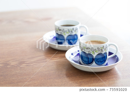 Two coffee cups and saucers on the table 73591020