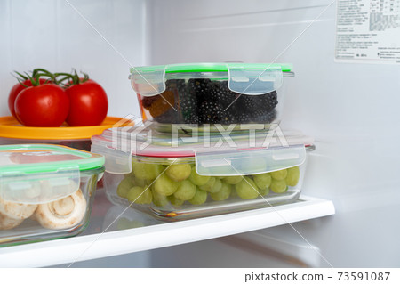 Storage containers with fresh food in a fridge Storage containers with fresh food in a fridge 73591087