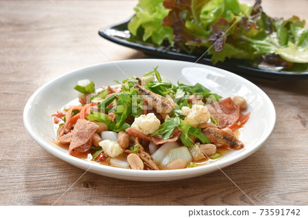 crispy fish with pork couple maw topping peanut in spicy and sour chili sauce salad on plate crispy fish with pork couple maw topping peanut in spicy and sour chili sauce salad on plate 73591742