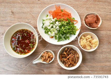 ingredient of crispy fish with pork couple maw topping peanut in spicy and sour chili sauce salad on plate ingredient of crispy fish with pork couple maw topping peanut in spicy and sour chili sauce salad on plate 73591743