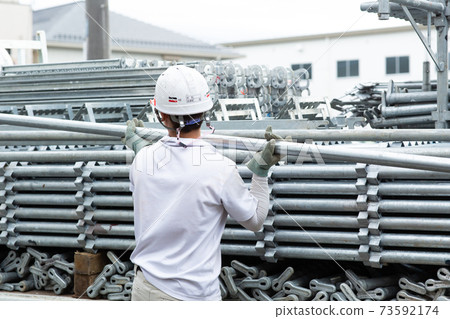 Craftsman dismantling the scaffolding Craftsman dismantling the scaffolding 73592174