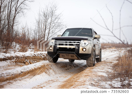Mitsubishi Pajero/Montero at dirt road in winter 73592603