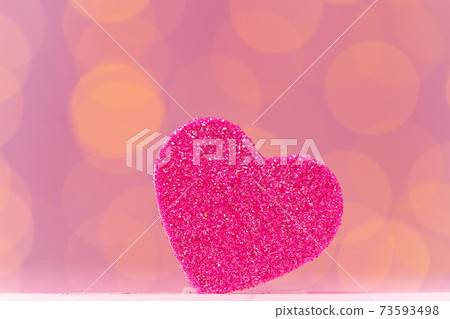 Pink glitter heart decoration on pink background 73593498