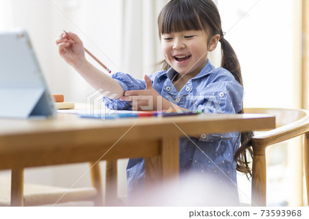 Girl studying on a tablet PC Girl studying on a tablet PC 73593968