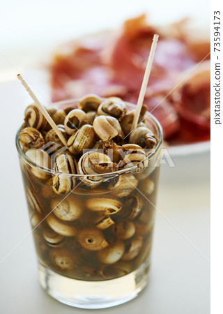 spanish caracolillos en caldo, a recipe of snails 73594173