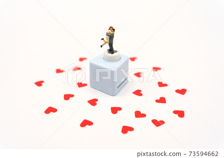 Miniature people standing with Heart shaped red paper. Red heart is the promise of love.  as background Valentine concept with copy spaces for your text or design. 73594662