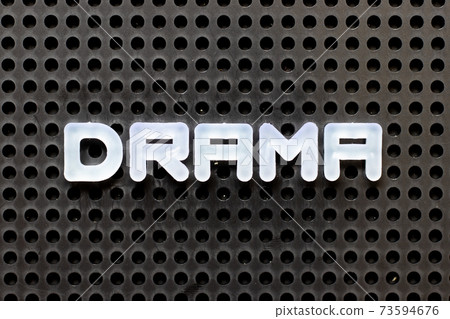 White color alphabet with word drama on black pegboard background White color alphabet with word drama on black pegboard background 73594676
