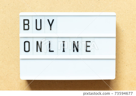 Lightbox with word buy online on wood background Lightbox with word buy online on wood background 73594677