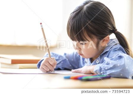 A girl studying in the living room 73594723
