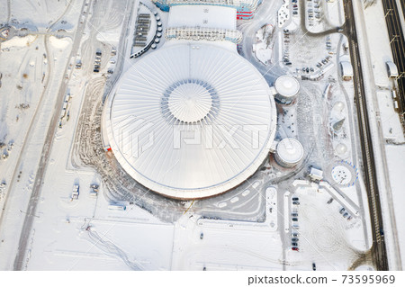 Top view in winter of a modern sports complex with parking in Minsk. Belarus 73595969