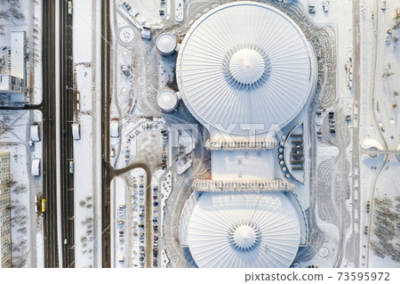 Top view in winter of a modern sports complex with parking in Minsk. Belarus 73595972