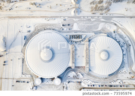 Top view in winter of a modern sports complex with parking in Minsk. Belarus 73595974