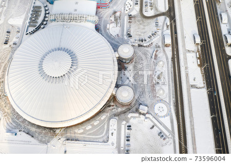 Top view in winter of a modern sports complex with parking in Minsk. Belarus 73596004