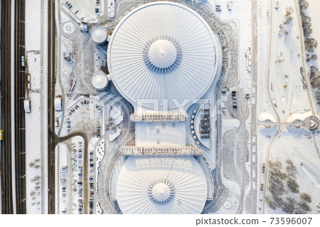 Top view in winter of a modern sports complex with parking in Minsk. Belarus 73596007