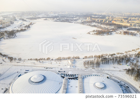 Top view in winter of a modern sports complex with parking in Minsk. Belarus 73596021