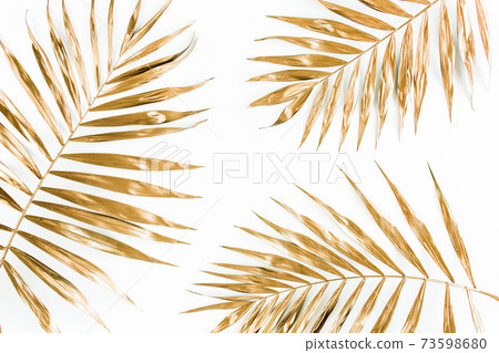 Gold tropical palm leaves on white background. Flat lay, top view minimal concept. Gold tropical palm leaves on white background. Flat lay, top view minimal concept. 73598680