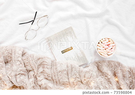 Home office on bed with warm plaid. Mockup card. Flat lay, top view 73598804