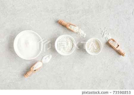 Female skin and body care cosmetic products set: facial cream, cosmetic clay, sea salt on gray marble background. Beauty blogger, salon treatments Female skin and body care cosmetic products set: facial cream, cosmetic clay, sea salt on gray marble background. Beauty blogger, salon treatments 73598853