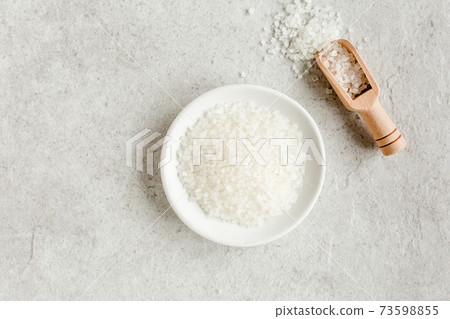 Spa skincare concept. Natural Organic spa cosmetics products, sea salt on gray marble table from above. Spa background flat lay, top view. Spa skincare concept. Natural Organic spa cosmetics products, sea salt on gray marble table from above. Spa background flat lay, top view. 73598855