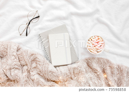 Home office on bed with warm plaid. Mockup card. Flat lay, top view Home office on bed with warm plaid. Mockup card. Flat lay, top view 73598858