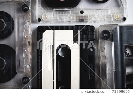 Many classic audio cassette tape with magnetic tape inside. Retro background Many classic audio cassette tape with magnetic tape inside. Retro background 73599695