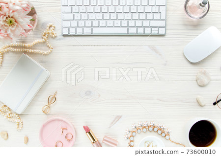 Top view office desk. Workspace with, computer, chrysanthemum, clipboard. Women's fashion accessories isolated on white wooden background. Flat lay Top view office desk. Workspace with, computer, chrysanthemum, clipboard. Women's fashion accessories isolated on white wooden background. Flat lay 73600010
