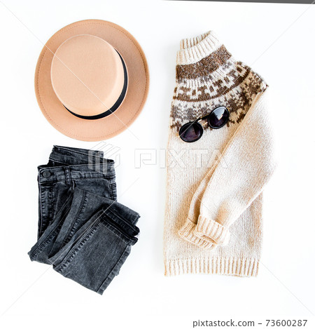Women fashion clothes and accessories. Feminine youth collage top view. Flat lay female style look with warm sweater, jeans, boot. Top view. 73600287