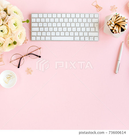 Stylized, pink women's home office desk. Workspace with computer, bouquet ranunculus and roses, clipboard on pink background. Flat lay. Top view. Stylized, pink women's home office desk. Workspace with computer, bouquet ranunculus and roses, clipboard on pink background. Flat lay. Top view. 73600614