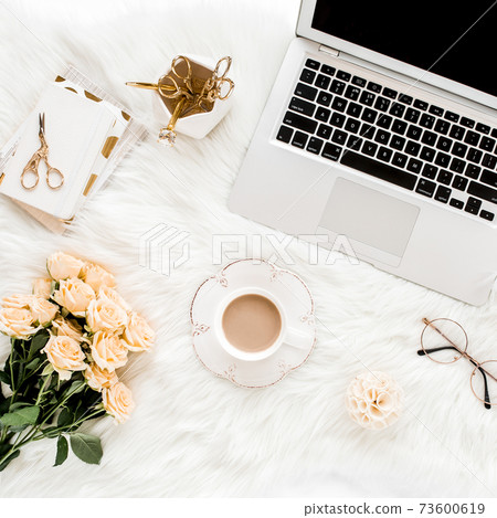 Female workspace with laptop, roses flowers, golden accessories, diary, computer, glasses on white background. Flat lay women's office desk. Top view Female workspace with laptop, roses flowers, golden accessories, diary, computer, glasses on white background. Flat lay women's office desk. Top view 73600619