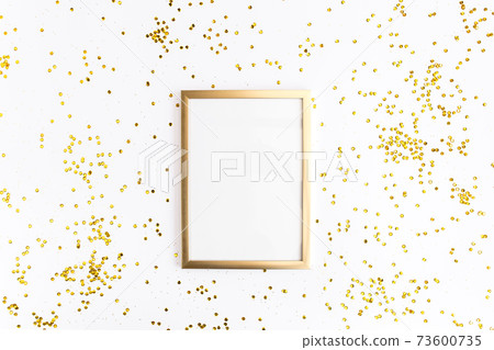 Photo frame mock up with space for text, golden confetti on white background. Lay Flat, top view. Valentine's minimal background. Photo frame mock up with space for text, golden confetti on white background. Lay Flat, top view. Valentine's minimal background. 73600735