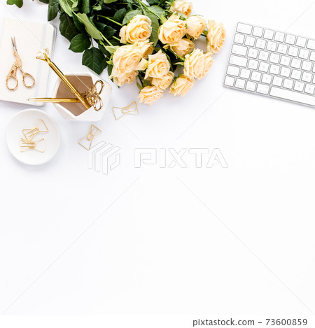 Female workspace with computer, roses flowers, golden accessories, diary, laptop, glasses on white background. Flat lay women's office desk. Top view 73600859