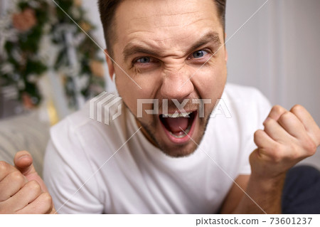 young man in earphones is talking to somebody young man in earphones is talking to somebody 73601237