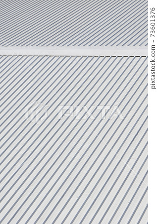 Metal gray roof with rhythmic parallel relief directions Metal gray roof with rhythmic parallel relief directions 73601376
