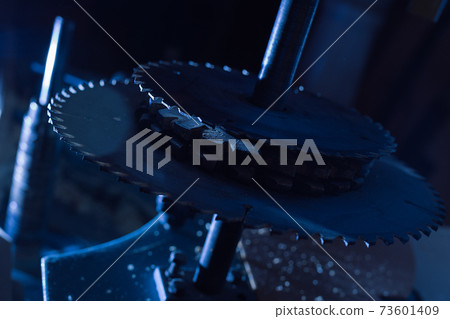 Sharp circular saw blades close up. Dangerous machine to cut up from horror films. Sharp circular saw blades close up. Dangerous machine to cut up from horror films. 73601409