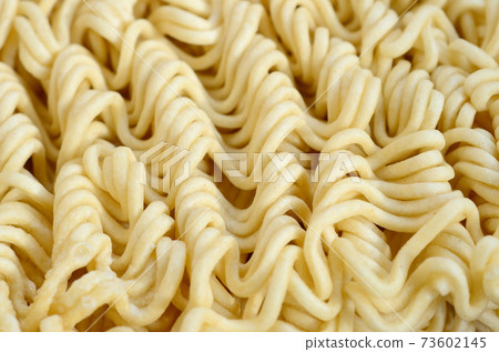 Close up view of yellow dry instant noodles. Chinese traditional food Close up view of yellow dry instant noodles. Chinese traditional food 73602145