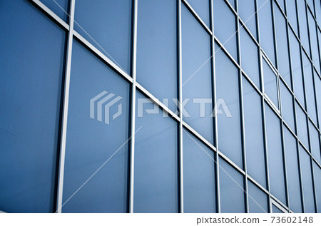 Solid blue windows of the office building. Glass wall 73602148