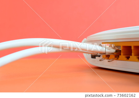 The Internet cable plugs are connected to the Internet router, which lies on a bright orange background. Items required for Internet connection 73602162