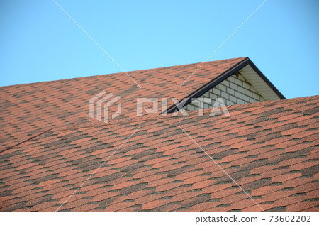 The roof is covered with bituminous shingles of brown color. Quality Roofing 73602202