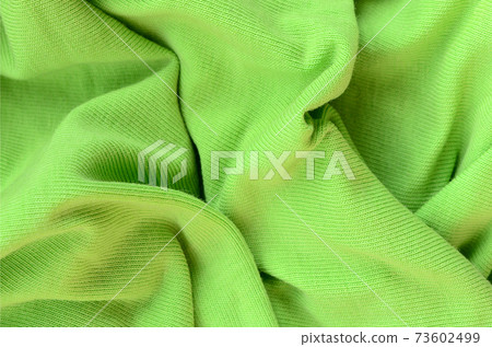 The texture of the fabric is bright green. Material for making shirts and blouses 73602499