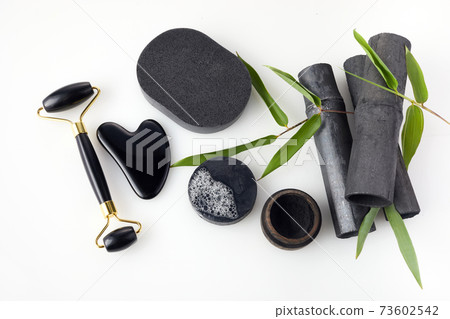 Bamboo charcoal eco friendly cosmetics products. Toothbrush and soap with skin cleansing and guasha 73602542