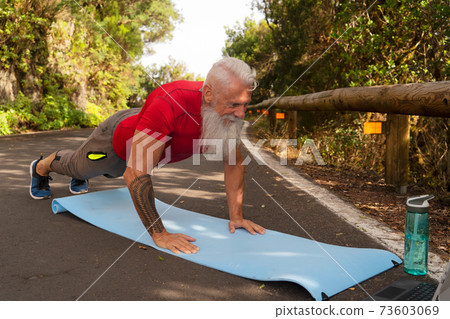 Senior man doing sport exercises 73603069