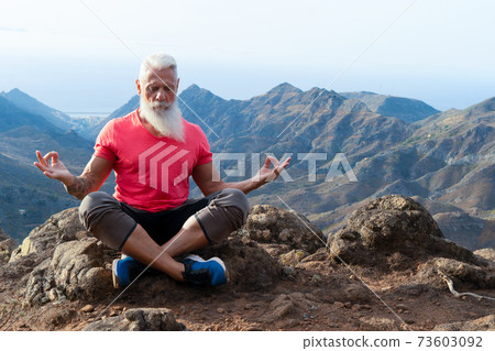 Senior man greeting sunset 73603092